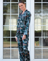 Model wearing The Hunt satin pyjama set, showing the button-front shirt and matching printed trousers.